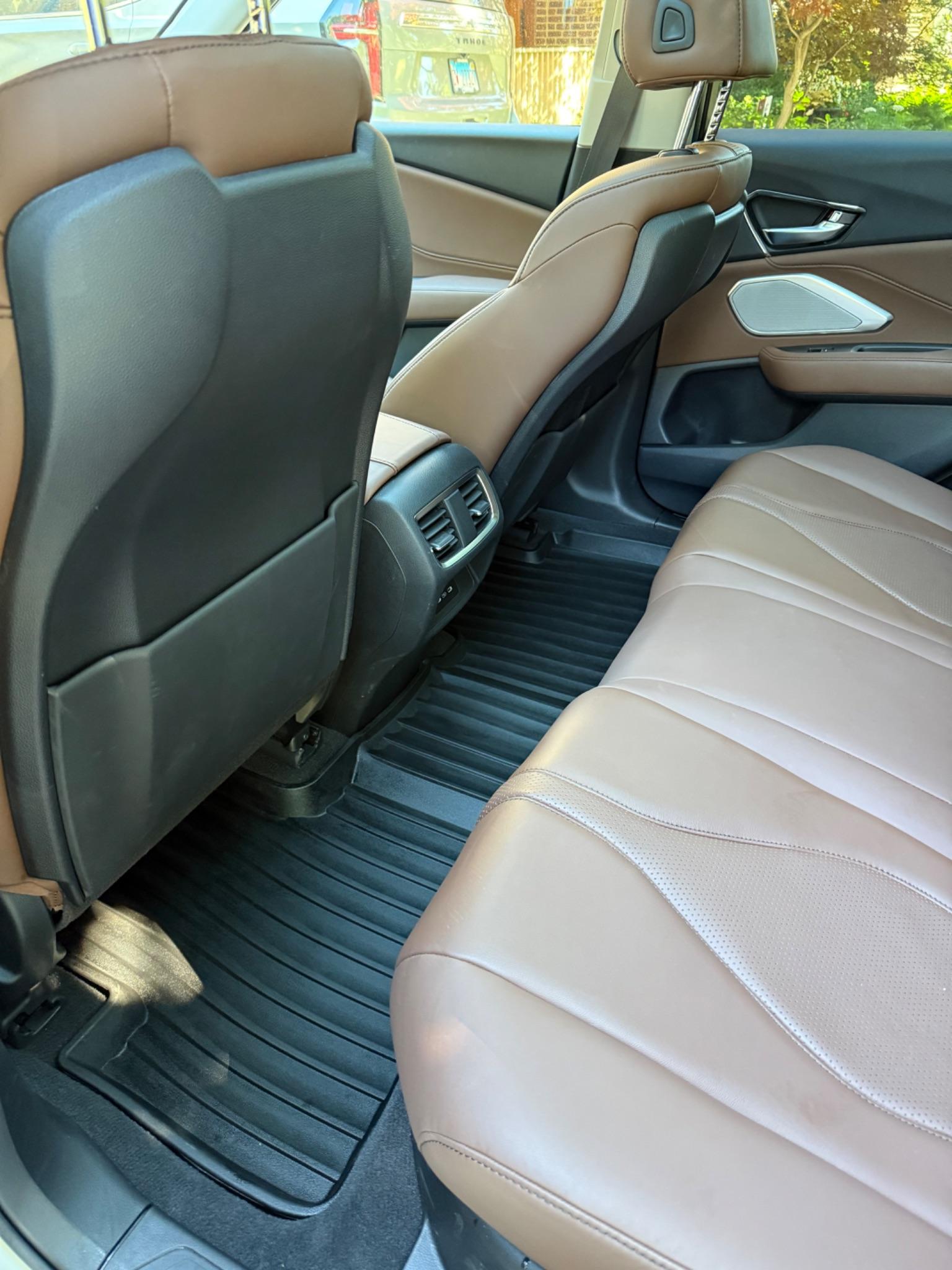 Clean rear seats and floor mats inside a Toyota RAV4