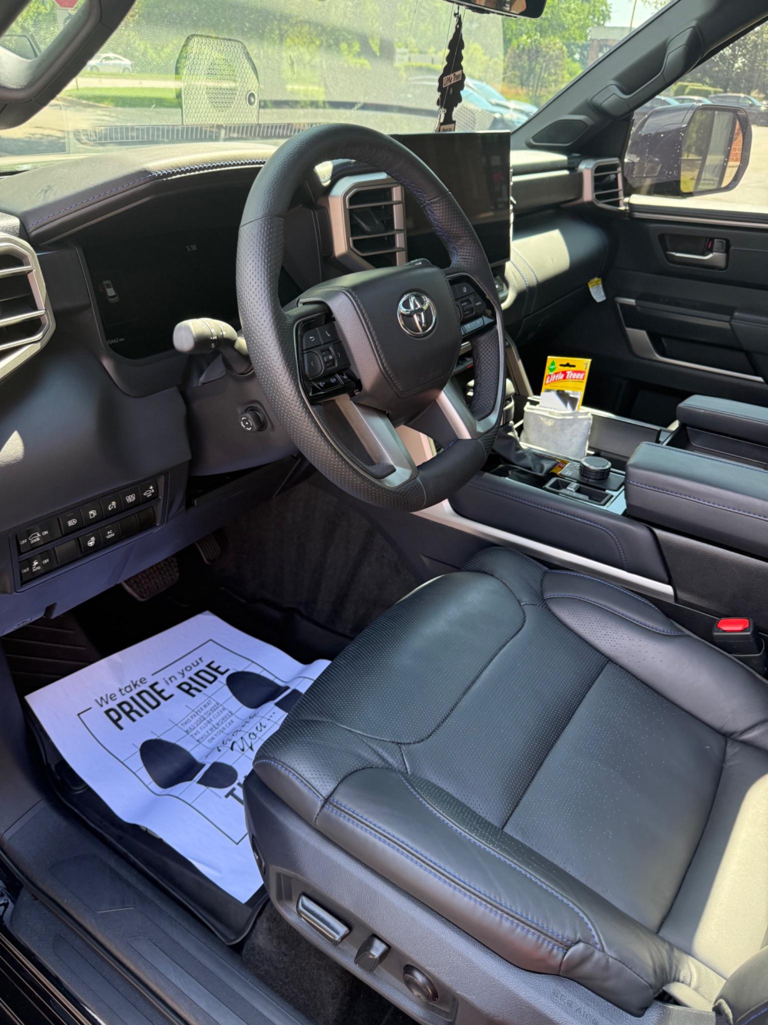 Clean black leather driver interior after detailing